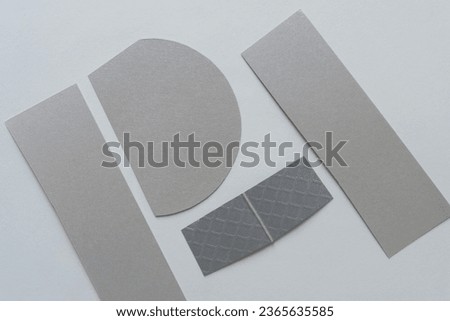 cut silver paper card stock shapes on blank paper