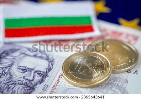 Bulgaria entry into the Eurozone and adoption of the European currency, Economic concept, Euro coins and Bulgarian money and flag Royalty-Free Stock Photo #2365643641