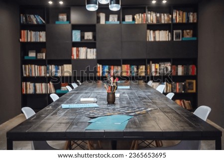 Modern stylish library with black furniture and variety of books