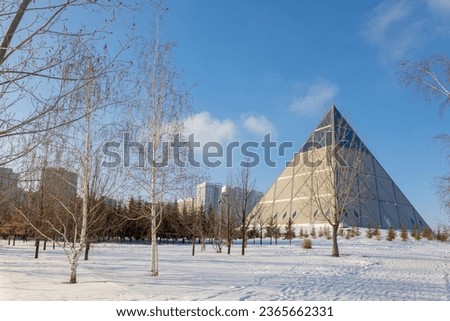 Palace of Peace and Accord. Modern architectural urbanistic city Astana. Futuristic building pyramids on sunny winter day, Nur-Sultan, Astana, Kazakhstan. High quality photo