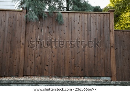 wooden fence, weathered and textured, evoking nostalgia and rural charm, against a soft-focus background, ideal for conveying authenticity and homely warmth Royalty-Free Stock Photo #2365666697