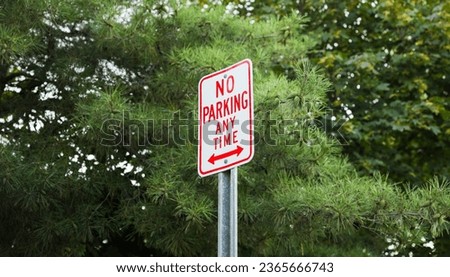 No Parking sign, rusted and aged, against a blurred urban background, conveying urban 