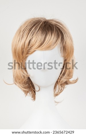 Natural looking blonde fair wig on white mannequin head. Short hair cut on the plastic wig holder isolated on white background, front view
 Royalty-Free Stock Photo #2365672429