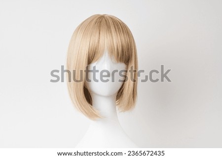 Natural looking blonde fair wig on white mannequin head. Short hair cut on the plastic wig holder isolated on white background, front view
 Royalty-Free Stock Photo #2365672435
