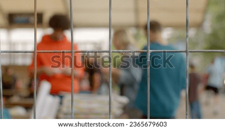 Youth rights in prison. Troubled teen industry to refer to broad range of youth residential programs aimed at struggling teenagers. Rehabilitation behavior modification. Background bokeh behind bars  Royalty-Free Stock Photo #2365679603