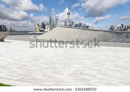 empty concrete floor with modern cityscape and sky for copy space.