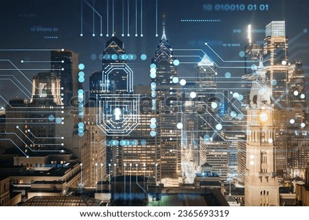 Aerial panoramic cityscape of Philadelphia financial downtown at night time, Pennsylvania, USA. Glowing Padlock hologram. The concept of cyber security to protect companies confidential information