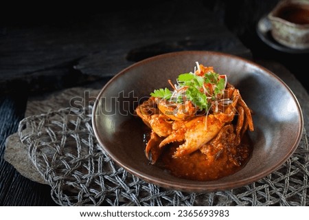 singapore chili crab on dark background. Close up food  Royalty-Free Stock Photo #2365693983