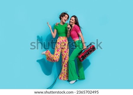 Full body size photo of couple youngsters sing crazy vocal loud voice mic with vintage playlist boombox isolated on blue color background