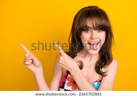 Photo of impressed funky lady wear flower print singlet showing two fingers empty space isolated yellow color background