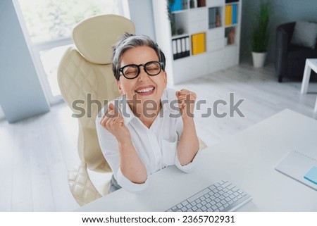 Photo of lucky smiling lady employer dressed white shirt getting working industry increase indoors workstation workshop
