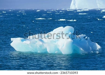 The ice on the continent of Antarctica, where ice mountains melt into the sea, is widely recognized for its stunning and beautiful natural phenomena. Royalty-Free Stock Photo #2365710393