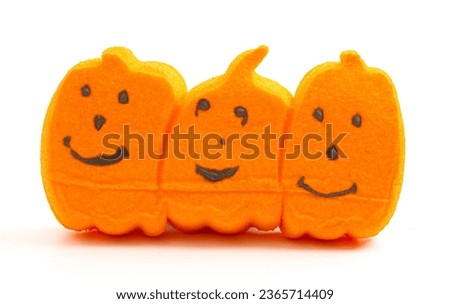 Classic Holiday Marshmallows in the Shape of Pumpkin Jack O Lanterns on a White Background Royalty-Free Stock Photo #2365714409