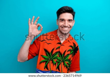 Portrait of funny guy showing fingers okey sign feedback good job summertime sale promo person model isolated on blue color background