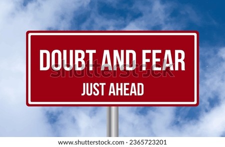 Doubt and Fear just ahead road sign on sky background