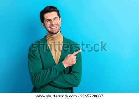 Photo of successful cheerful person toothy smile look direct finger empty space proposition isolated on blue color background
