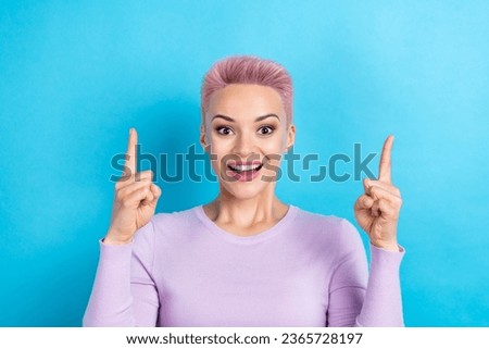 Photo of overjoyed lady open mouth directing fingers empty space awesome ads adv ad offer isolated blue color background