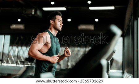 Young Asian Man Running on Treadmill - Fitness Gym Exercise Royalty-Free Stock Photo #2365731629