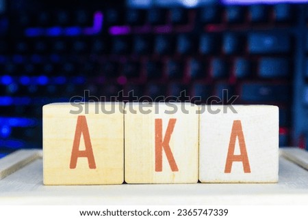Photo of words with wooden block objects arranged into the word "AKA" in English