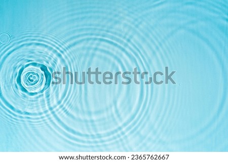 Pattern of circles on clear water from drops Royalty-Free Stock Photo #2365762667