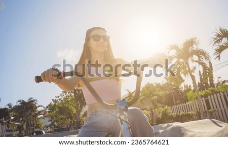 Happy young woman enjoy BMX riding at the skatepark