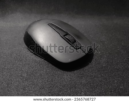 "Elegant black mouse on a sleek black background - a stylish and minimalistic tech concept. Perfect for modern designs. 