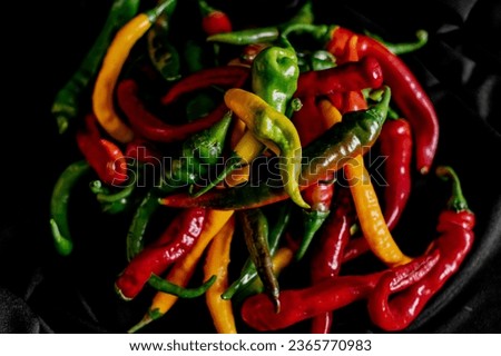 red, green and yellow hot pepper on a gray background. bright colors of summer vegetables