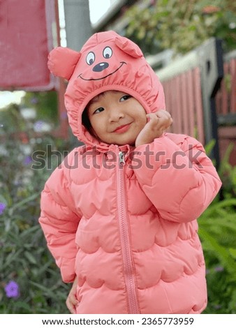 Girl wearing a cartoon bear winter coat
