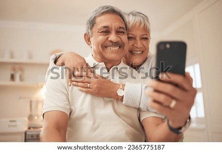 Senior couple, home and smile with smartphone for video call, mobile streaming and scroll on social media in retirement. Happy old man, woman and hug with phone for selfie, reading news app and relax Royalty-Free Stock Photo #2365775187
