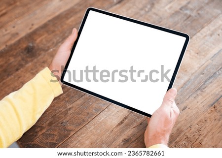 Man using tablet computer, empty screen mockup