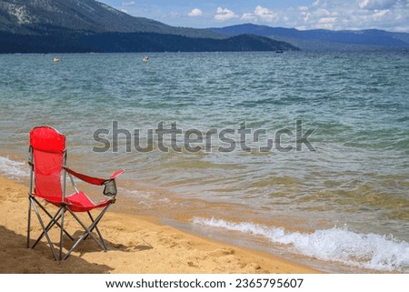 Red chair on Pope Beach on a sunny summer day. South Lake Tahoe. 