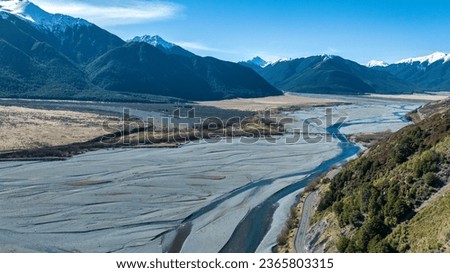 Aerial photography of the braided river with very little water flowing through the alpine Arthurs Pass