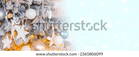 Christmas background. Charming Christmas Fir Bedecked with Sparkling Blue and Rose Ornaments, Illuminated by Soft String Lights.