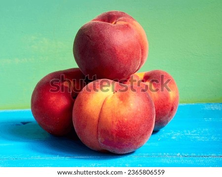 Ripe peaches in the bright sun on a blue background
