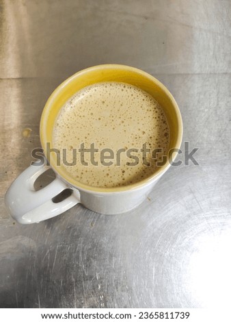 Portrait of a cup of espresso coffee on a stainless table ready to be enjoyed