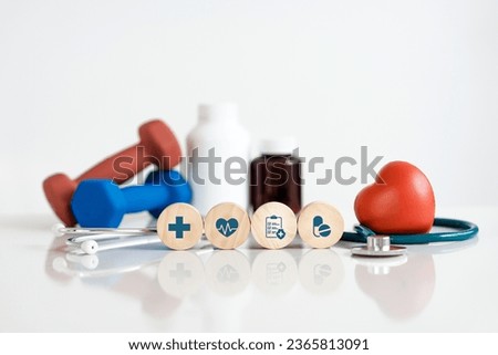 Wooden cubes with icons of medical or health care. Red heart and stethoscope for health care and health insurance concept. plan medicine treatment and yearly health check.