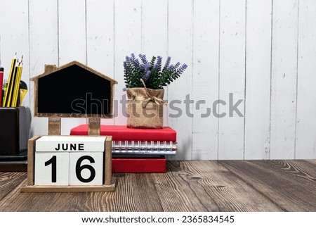 June 16 calendar date text on white wooden block on wooden desk