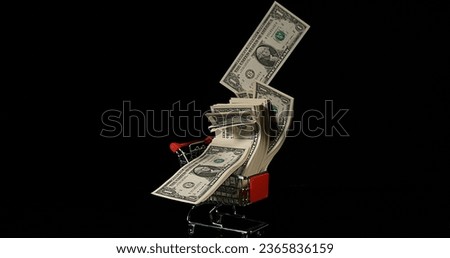 Dollar Coins in Trolley rolling against Black Background