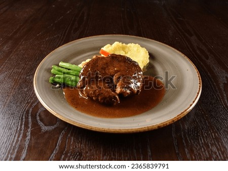 bbq grilled juicy wagyu beef tenderloin sirloin steak in brown black pepper sauce with French fries and vegetables salad in plate on marble table western cuisine halal food hotel luxury cafe menu Royalty-Free Stock Photo #2365839791