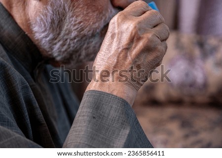 Old man drinking coffee with smile on his face