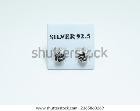 Silver earrings display on white background