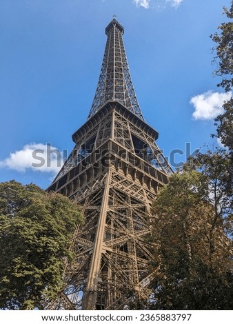 Eifeltower from the bottom with Dome Clouds in blue sky Royalty-Free Stock Photo #2365883797