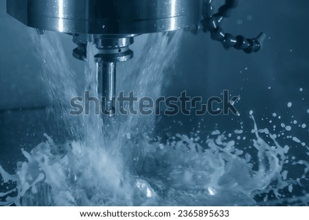The CNC milling machine cutting the tire mold parts with oil coolant method. The mold and die manufacturing process by machining center with the solid ball endmill tools. Royalty-Free Stock Photo #2365895633