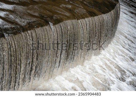 A weir taken with fast shutter speed - highlighting the ripples in the water going over the edge