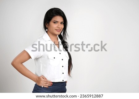 Beautiful smiling young Indian woman on white background
