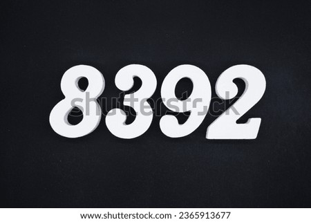 Black for the background. The number 8392 is made of white painted wood.