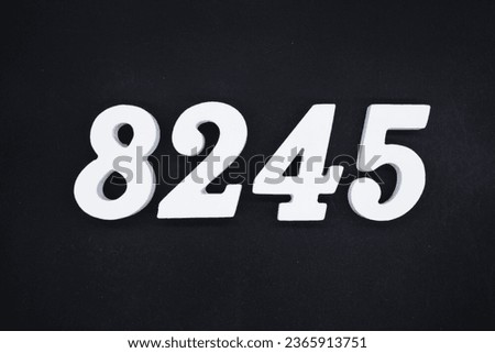 Black for the background. The number 8245 is made of white painted wood.