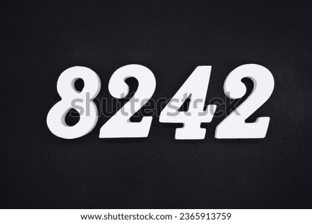 Black for the background. The number 8242 is made of white painted wood.