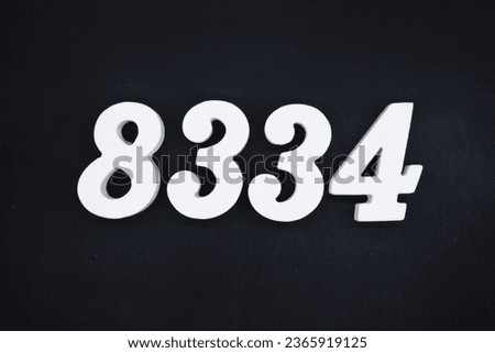 Black for the background. The number 8334 is made of white painted wood.