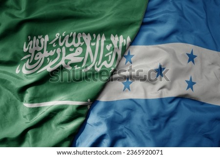 big waving realistic national colorful flag of saudi arabia and national flag of honduras . macro
